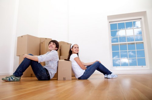 Professional movers unloading boxes at a Westend home