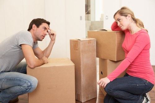 Staff member using lifting equipment and safety gear in a removals setting