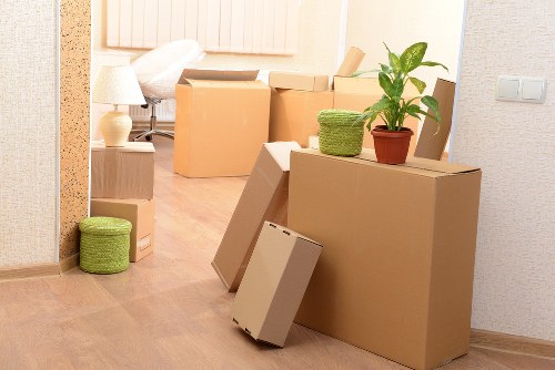 Packed moving boxes and furniture ready for transport in Westend
