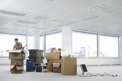 Moving team carrying furniture through a Westend apartment corridor