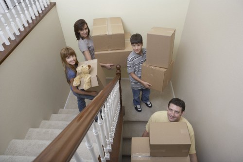 Movers protecting a piano and surrounding property during removal